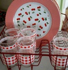 red gingham cups and plates on a wire rack