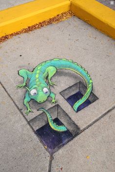 a drawing of a lizard on the sidewalk