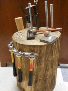 a wooden table topped with lots of different types of tools on top of each other