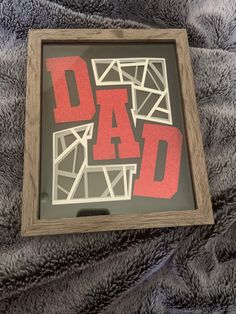 a wooden frame with the words dad on it