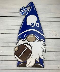 a gnome with a football on it's nose wearing a blue and white hat