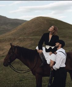 a man and woman riding on the back of a brown horse