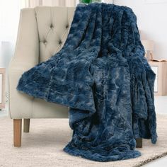 a blue blanket sitting on top of a chair