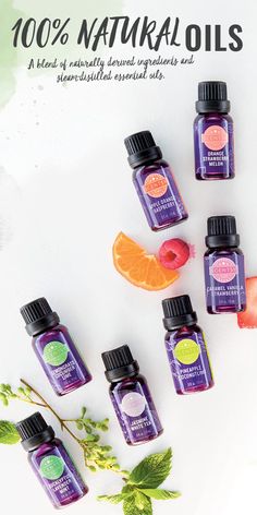 bottles of essential oils with orange slices and leaves