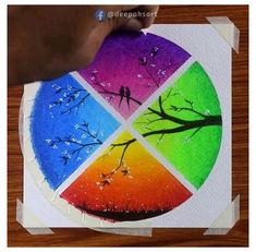 someone is drawing on paper with colored pencils and watercolor paints in the shape of a tree