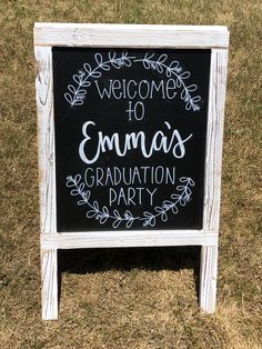 a chalkboard sign that says welcome to emma's graduation party