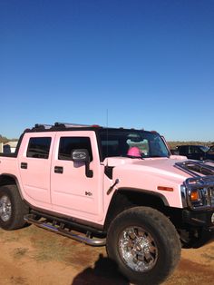 a pink hummer truck parked in the desert