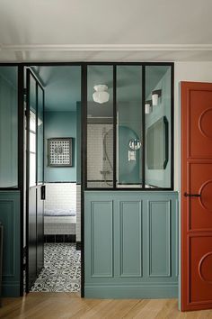 the instagram page shows an image of a bathroom with blue walls and green cabinets