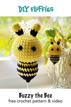 two crocheted bees sitting next to each other on top of a window sill