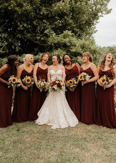 Bridesmaids wearing burgundy red bridesmaid dresses with sunflower bouquets with the bride in a mermaid wedding dress Burgundy Red Bridesmaid Dresses, Red And Yellow Bridesmaid Dresses, Sunflower Bridesmaid Dresses, Rose Red Bridesmaid Dresses, Autumn Wedding Dresses, Bridesmaid Dresses Autumn, Sunflower Wedding Bridesmaid Dresses, Fall Wedding Colors Bridesmaid Dresses, Red Bridesmaids Dresses