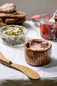 a table topped with lots of food and wooden utensils