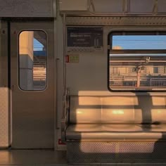 an empty train car with the door open and sunlight coming through it's windows