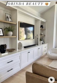 a living room filled with furniture and a flat screen tv on top of a wall