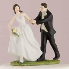 a bride and groom figurine holding hands