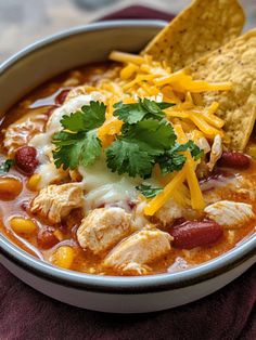 a bowl of chicken chili with tortilla chips