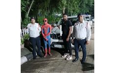 three men standing next to each other in front of a car with a spider man on it