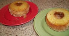 two small pastries sitting on top of green and red plates next to each other