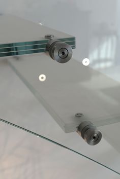 two cameras mounted to the side of a glass wall