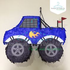 a blue monster truck pinata hanging on the wall