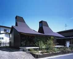 the house is made out of black shingles