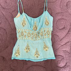 Gorgeous Aqua Sheer Embellished Silk. Beading & Gold Embroidery. Pull Over With Side Button Closure. Fully Lined Minor Thread Pulling By Base Of Button Closure . Extra Rhinestones Great Condition Fitted Blue Tops With Mirror Work, Blue Party Top With Mirror Work, Fitted Beaded Top For Festive Season, Festive Fitted Beaded Top, Festive Beaded Fitted Top, Blue Mirror Work Party Top, Blue Embellished Sleeveless Top, Fitted Blue Embellished Blouse, Blue Summer Festival Top