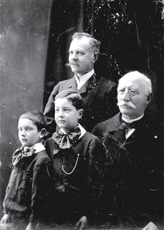 an old black and white photo of four people