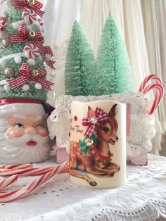 two christmas mugs sitting next to each other on a table