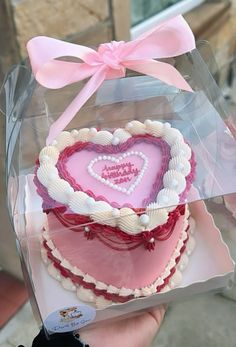 a heart shaped cake in a clear box