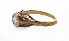 A modern reproduction of a classic antique. 14K yellow gold, tall bezel setting, .50ct round RB Diamond, GIA E SI1 (ARC 3K). Open filigree design with floral and chevron patterns on the shank. Size 7 1/2. This is a consignment piece. Art Deco Gold Filigree Ring With Rose Cut Diamonds, Vintage Engraved Ring With Intricate Design For Formal Occasions, Elegant Engraved Ring With Bezel Setting For Formal Occasions, Vintage 14k Gold Diamond Ring With Bezel Setting, Ornate Gold Diamond Ring For Formal Events, Ornate Gold Diamond Ring For Formal Occasions, Vintage Yellow Gold Filigree Ring With Round Cut, Vintage Gold Diamond Ring With Bezel Setting, Ornate Yellow Gold Diamond Ring