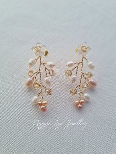 Truly beautiful bridal earrings, with a drop of approximately 4.5cm. Handmade with hand carved Mother of pearl flowers, quality natural ivory and blush pink freshwater pearls with the finest quality champagne crystals set on a Gilt gold plated, copper wire showing intricate detailing. All of our items are made to order so adjustments can be made with regards to materials and designs. Please message us if you require different specifications.  The design is handmade featuring natural freshwater p Handmade Delicate Pearl Earrings, Rose Gold Pearl Drop Flower Earrings, Rose Gold Flower Drop Earrings With Pearl, Anniversary Rose Gold Pearl Earrings, Elegant Pierced Cluster Earrings For Wedding, Wedding Pearl Drop Earrings In Flower Shape, Delicate Pearl Dangle Earrings, Delicate Dangle Pearl Earrings, Rose Gold Flower-shaped Earrings With Pearl Drop