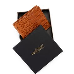 Improved classic design Embossed full grain vegetable tanned premium leather RFID - protected 3.3"H x 4.1"W x 0.5"D (folded) Holds 6 – 12 cards 2 slip pockets Flat bill section Fabric lining Branded gift box Imported Brown Bifold Card Holder For Formal Use, Cognac Rectangular Wallet Perfect For Gifts, Rectangular Cognac Wallet Perfect For Gifts, Formal Brown Bifold Card Holder, Luxury Smooth Grain Wallets As Gift, Luxury Brown Trifold Wallet As Gift, Bifold Card Holder With Leather Lining As Gift, Classic Trifold Wallet With Coin Pocket As Gift, Rectangular Card Holder With Leather Lining For Gift