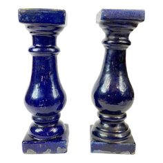 two blue candlesticks sitting next to each other