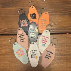 six different colored key chains with sayings on them