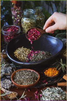 a person scooping out herbs from a bowl