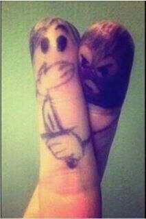 two feet with faces drawn on them and one is holding a doughnut in the other hand