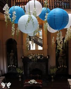 blue and white paper lanterns hanging from the ceiling