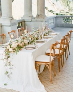 a long table with flowers and candles on it