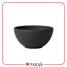 a black bowl sitting on top of a white table