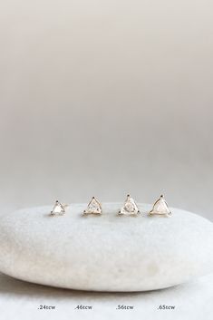 These studs bring the sparkle. The timeless diamond is given a modern twist with a sleek trillion cut. We love styling with the JP TINY DIAMOND STUDS and JP BAGUETTE STUDS. Throughout centuries of history and across endless cultures, the DIAMOND has been seen as invaluable. Associated with strength, love, health, and longevity, these zingers hold more than just a beautiful sparkle. Sold as a pair