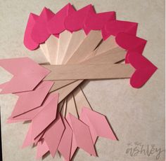 the paper flowers are cut out and placed on top of each other to make a wreath