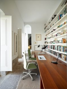 an office with bookshelves, desk and chair in the middle is featured in this magazine