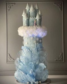 there is a cake made to look like a castle with clouds and stars on it