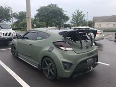 a green sports car parked in a parking lot