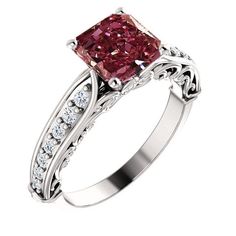 a pink diamond ring with white diamonds on the sides and an intricate band around it