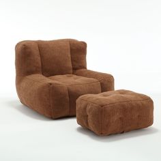 a brown chair and ottoman sitting next to each other on a white surface with one foot in the air