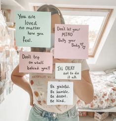 a woman is holding up signs with words written on them that say, you are loved, no matter how you feel