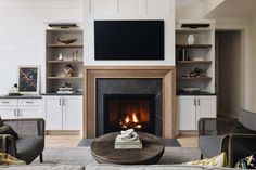 a living room filled with furniture and a flat screen tv mounted above a fire place