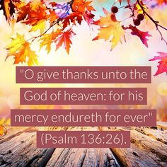 a wooden table topped with leaves and the words, o give thanks to the god of heaven