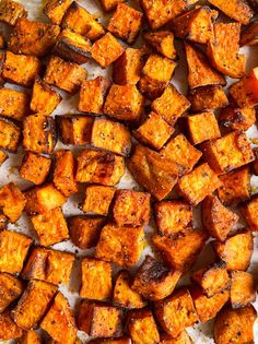 roasted sweet potatoes on a baking sheet ready to be cooked in the oven for dinner