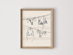 an art piece hanging on a clothes line with bras hung from it's wires